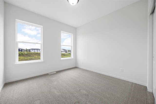 1442 Cardinal Dr, Fairfax, IA 52228 - empty room with carpet and healthy amount of natural light