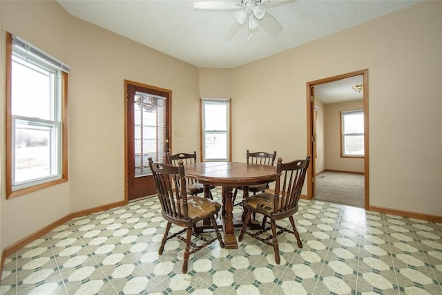 110 SE 12th St, Oelwein, IA 50662 - dining space featuring baseboards, a ceiling fan, and light floors