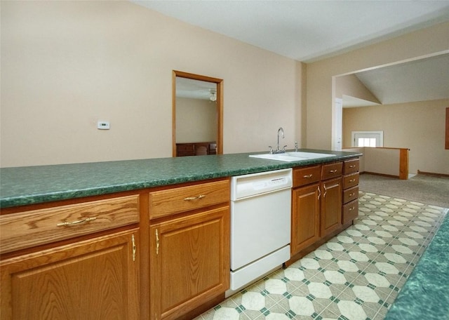 110 SE 12th St, Oelwein, IA 50662 - kitchen featuring dark countertops, brown cabinets, light floors, dishwasher, and a sink