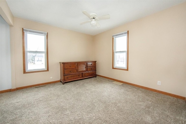 110 SE 12th St, Oelwein, IA 50662 - carpeted empty room featuring ceiling fan, baseboards, and visible vents