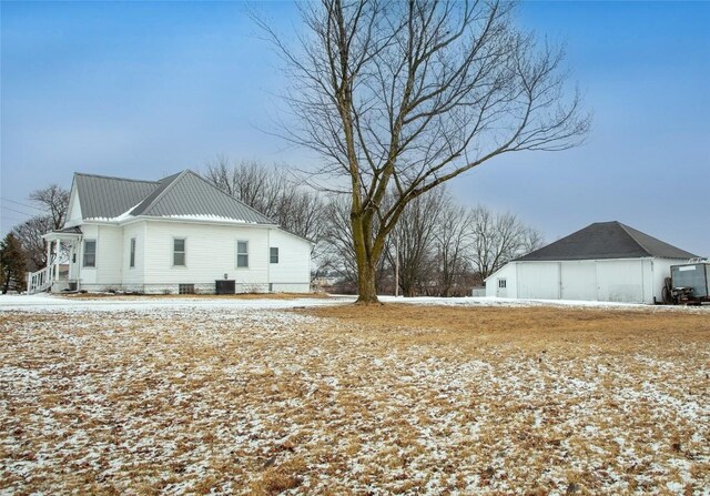 110 SE 12th St, Oelwein, IA 50662 - view of snowy exterior featuring metal roof