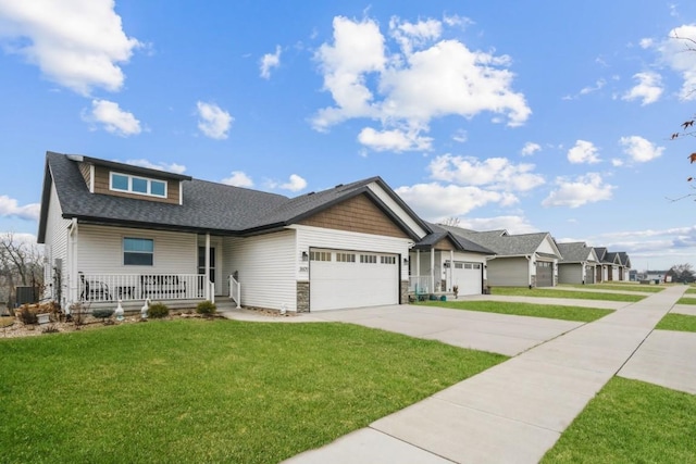 1609 Petrus Dr NE, Cedar Rapids, IA 52402 - view of front of house featuring covered porch, an attached garage, a front lawn, a shingled roof, and driveway