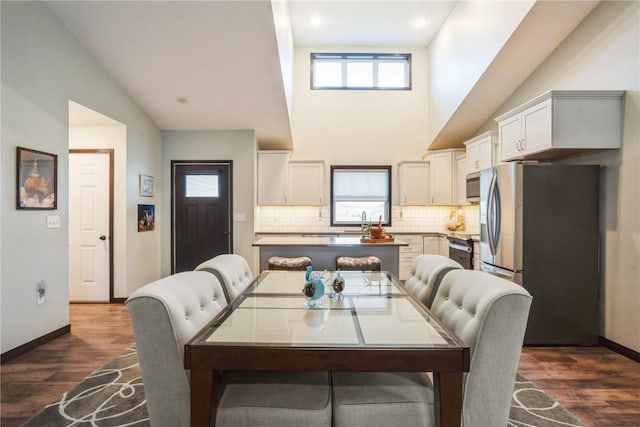 1609 Petrus Dr NE, Cedar Rapids, IA 52402 - dining space with high vaulted ceiling, plenty of natural light, dark wood-style flooring, and recessed lighting