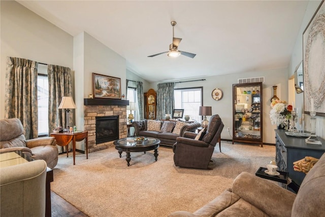 living area featuring a fireplace, ceiling fan, lofted ceiling, and visible vents