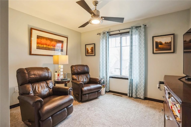 sitting room featuring light carpet, baseboards, a ceiling fan, and visible vents