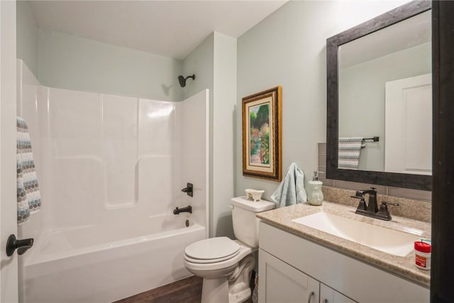 full bathroom featuring vanity, toilet, washtub / shower combination, and wood finished floors