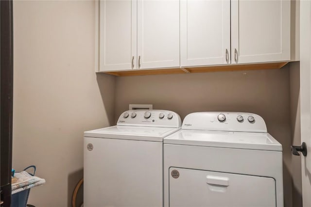 washroom with separate washer and dryer and cabinet space