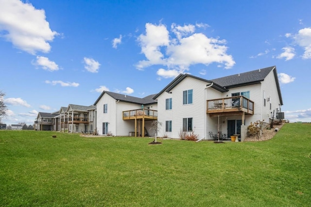 back of property featuring a lawn and a deck