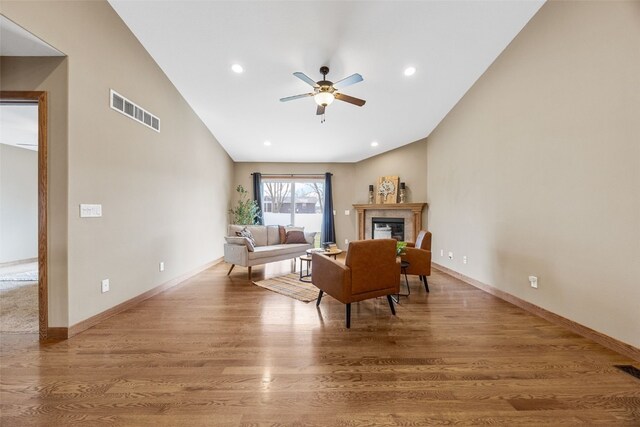345 Shannon Dr, Robins, IA 52328 - living area with a tiled fireplace, visible vents, ceiling fan, and wood finished floors
