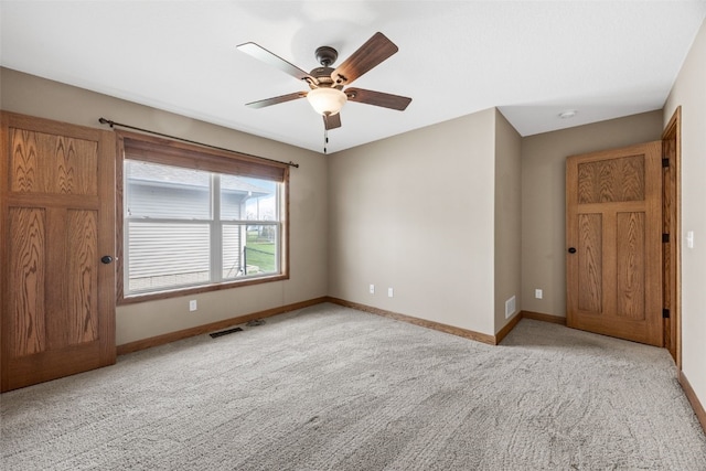 345 Shannon Dr, Robins, IA 52328 - spare room with light carpet, visible vents, baseboards, and a ceiling fan