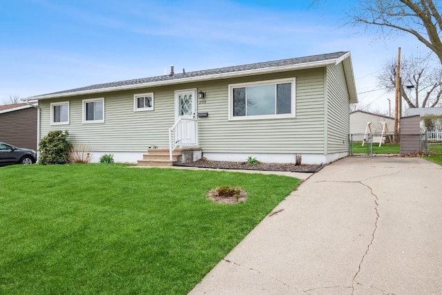 manufactured / mobile home featuring a front yard, fence, and a gate