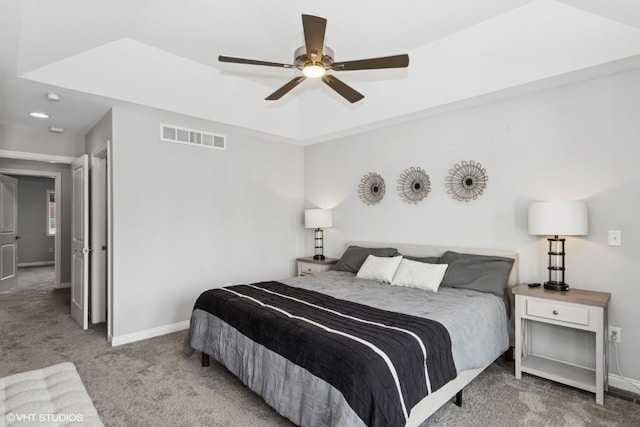 bedroom featuring visible vents, baseboards, ceiling fan, and carpet