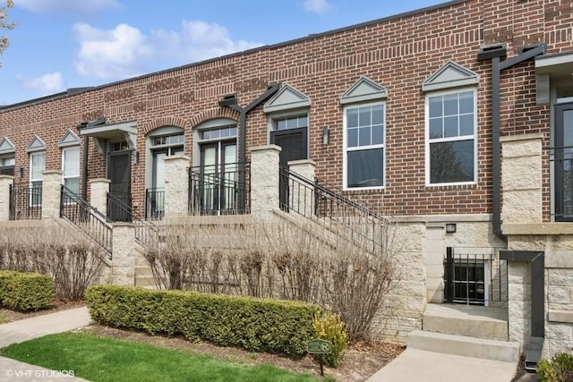 view of front of property featuring stone siding and brick siding