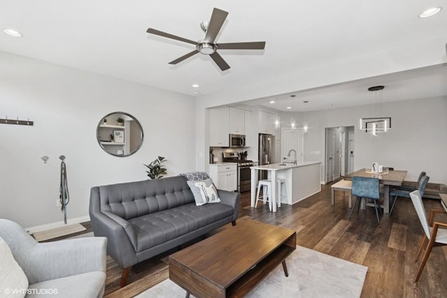 living room featuring dark wood finished floors, recessed lighting, baseboards, and a ceiling fan