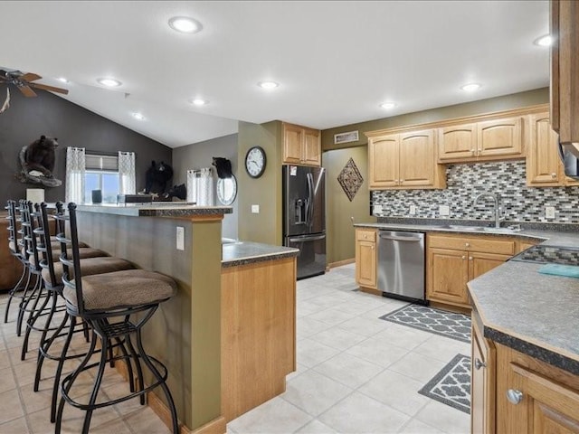3752 Lacina Dr SW, Iowa City, IA 52240 - kitchen with black refrigerator with ice dispenser, dishwasher, a sink, a breakfast bar, and a ceiling fan
