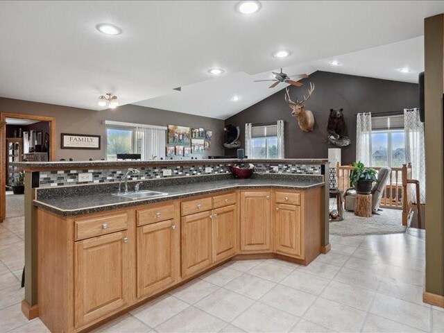 3752 Lacina Dr SW, Iowa City, IA 52240 - kitchen with a sink, ceiling fan, a wealth of natural light, backsplash, and light tile patterned flooring