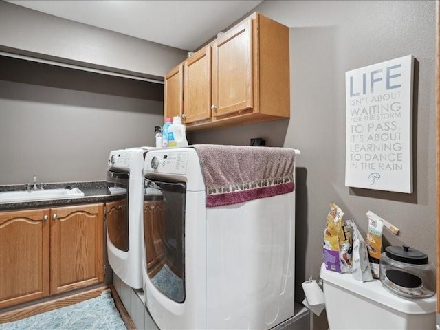 3752 Lacina Dr SW, Iowa City, IA 52240 - clothes washing area featuring washing machine and clothes dryer, a sink, and cabinet space