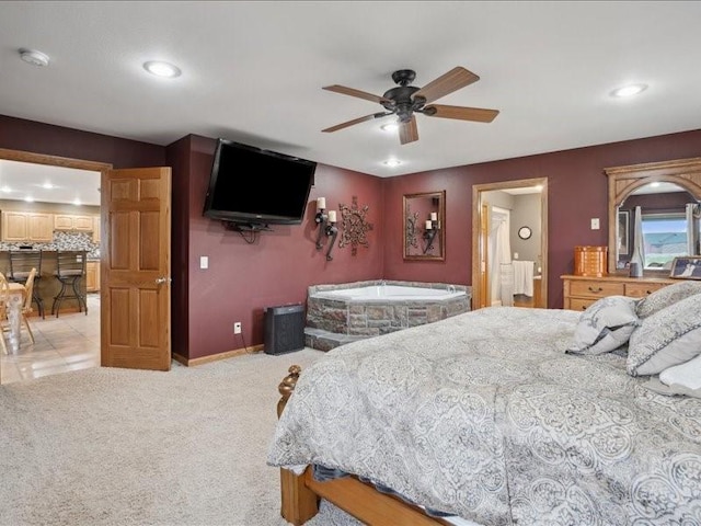 3752 Lacina Dr SW, Iowa City, IA 52240 - bedroom featuring baseboards, recessed lighting, a ceiling fan, connected bathroom, and light colored carpet