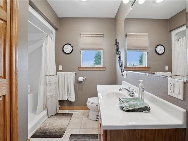 3752 Lacina Dr SW, Iowa City, IA 52240 - full bath featuring toilet, a healthy amount of sunlight, a shower with shower curtain, and tile patterned flooring