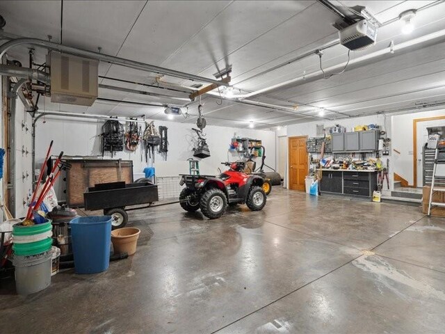 3752 Lacina Dr SW, Iowa City, IA 52240 - garage with a garage door opener and a workshop area