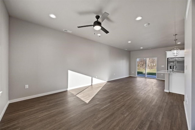 2068 Whispering Meadow Dr, Iowa City, IA 52240 - unfurnished living room featuring recessed lighting, dark wood-type flooring, baseboards, and a ceiling fan