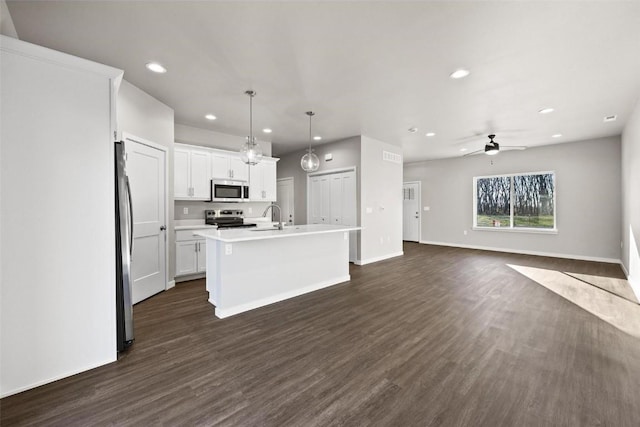 2068 Whispering Meadow Dr, Iowa City, IA 52240 - kitchen with dark wood-style flooring, recessed lighting, a ceiling fan, a kitchen island with sink, and stainless steel appliances