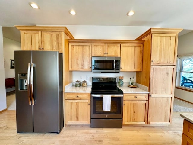 kitchen featuring recessed lighting, light countertops, baseboards, and stainless steel appliances
