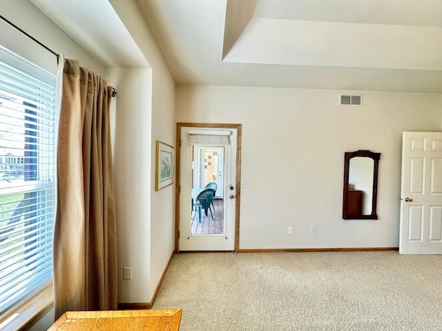 interior space with visible vents, baseboards, and light carpet