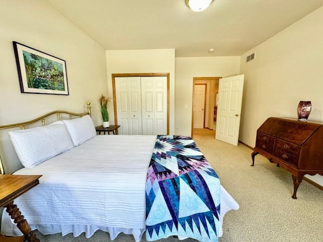 carpeted bedroom with a closet and visible vents