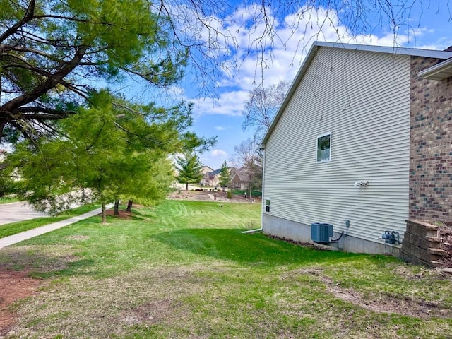 view of home's exterior featuring cooling unit and a lawn