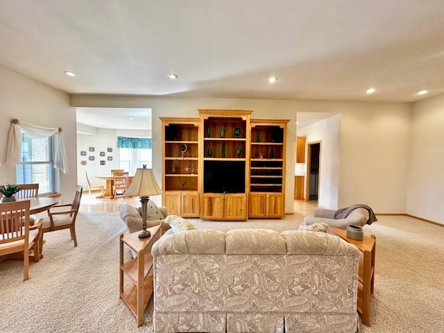 living room with baseboards, recessed lighting, and light colored carpet