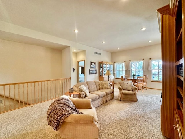 carpeted living area featuring visible vents and recessed lighting