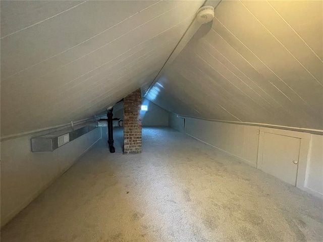 bonus room featuring vaulted ceiling and carpet floors