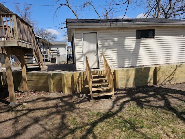 back of property featuring stairs and a wooden deck