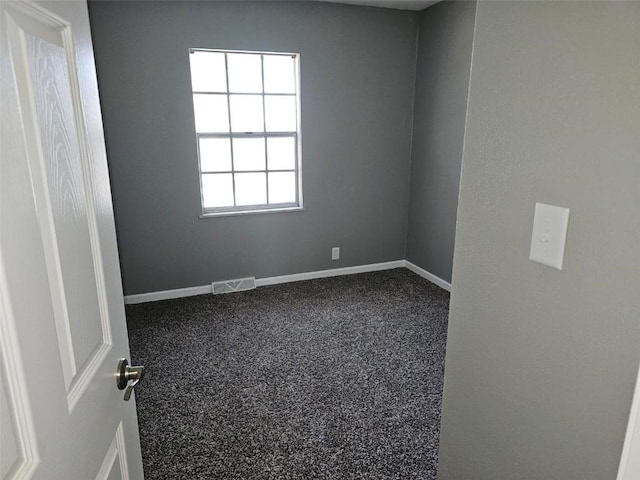 1025 Pawnee Dr NW, Cedar Rapids, IA 52405 - empty room with baseboards and dark colored carpet