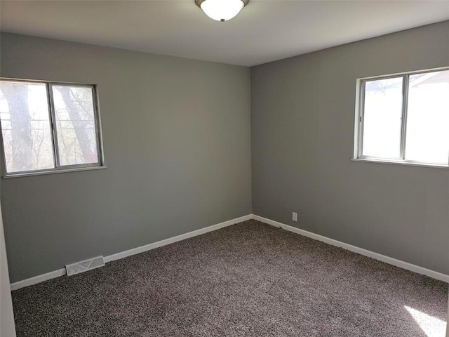 1025 Pawnee Dr NW, Cedar Rapids, IA 52405 - unfurnished room featuring dark colored carpet and baseboards