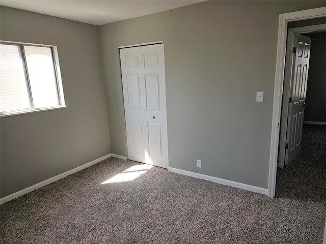 1025 Pawnee Dr NW, Cedar Rapids, IA 52405 - unfurnished bedroom with carpet floors, baseboards, and a closet