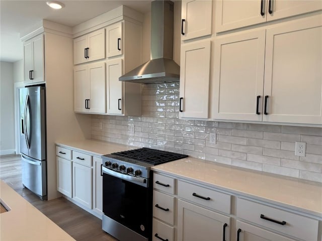 4018 Peridot Dr, Marion, IA 52302 - kitchen with wall chimney exhaust hood, appliances with stainless steel finishes, light wood-style floors, light countertops, and tasteful backsplash