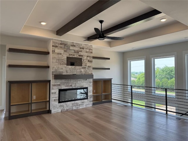 4018 Peridot Dr, Marion, IA 52302 - unfurnished living room with a ceiling fan, wood finished floors, beam ceiling, a fireplace, and recessed lighting