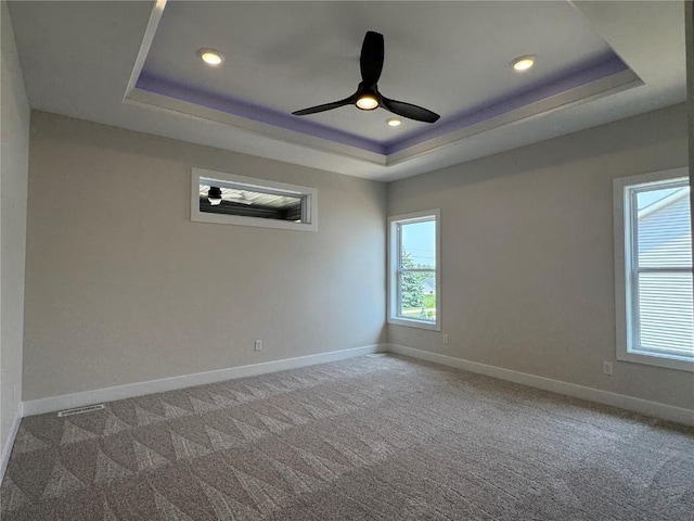 4018 Peridot Dr, Marion, IA 52302 - empty room featuring a raised ceiling, baseboards, ceiling fan, carpet floors, and recessed lighting