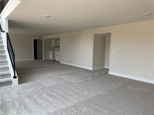 4018 Peridot Dr, Marion, IA 52302 - unfurnished living room with stairway, carpet, and baseboards