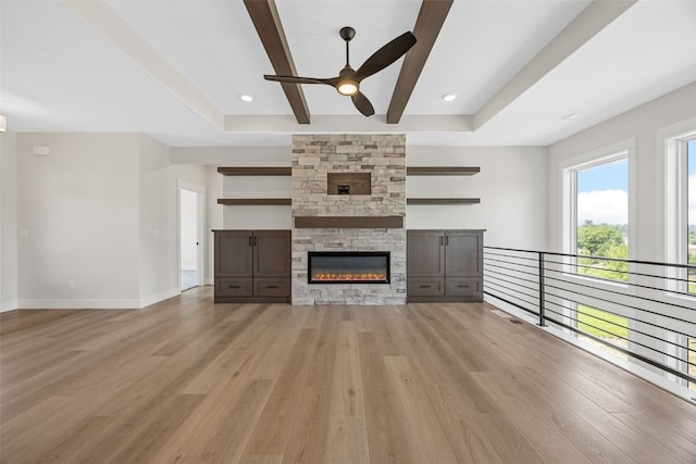 4018 Peridot Dr, Marion, IA 52302 - unfurnished living room with ceiling fan, light wood-style floors, a fireplace, and beam ceiling