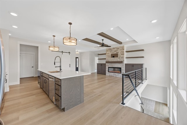 4018 Peridot Dr, Marion, IA 52302 - kitchen featuring a barn door, stainless steel dishwasher, light wood finished floors, light countertops, and recessed lighting