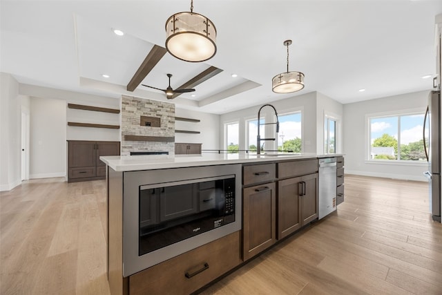 4018 Peridot Dr, Marion, IA 52302 - kitchen featuring appliances with stainless steel finishes, light countertops, ceiling fan, light wood-style floors, and hanging light fixtures