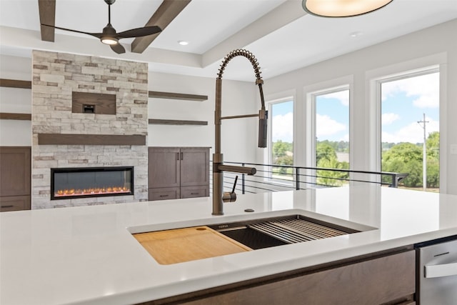 4018 Peridot Dr, Marion, IA 52302 - kitchen with a ceiling fan, a stone fireplace, recessed lighting, light countertops, and dishwasher