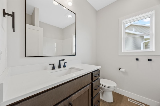 4018 Peridot Dr, Marion, IA 52302 - bathroom featuring vanity, wood finished floors, and a shower