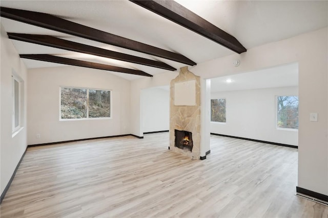 3111 Carroll Dr SE, Cedar Rapids, IA 52403 - unfurnished living room featuring baseboards, wood finished floors, and a stone fireplace