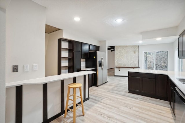 3111 Carroll Dr SE, Cedar Rapids, IA 52403 - kitchen with stainless steel fridge with ice dispenser, a peninsula, dishwashing machine, light wood finished floors, and recessed lighting