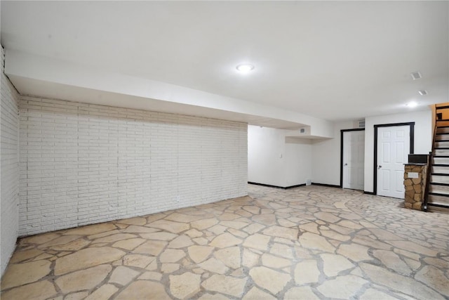 3111 Carroll Dr SE, Cedar Rapids, IA 52403 - finished below grade area featuring stone floors, stairway, brick wall, and recessed lighting