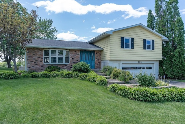 105 Parkview Dr, Tipton, IA 52772 - split level home with brick siding, an attached garage, and a front yard